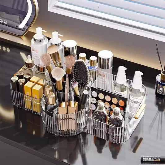 Clear multi-layer makeup storage rack holding brushes, lotions, lipsticks, and other cosmetic products on a black vanity