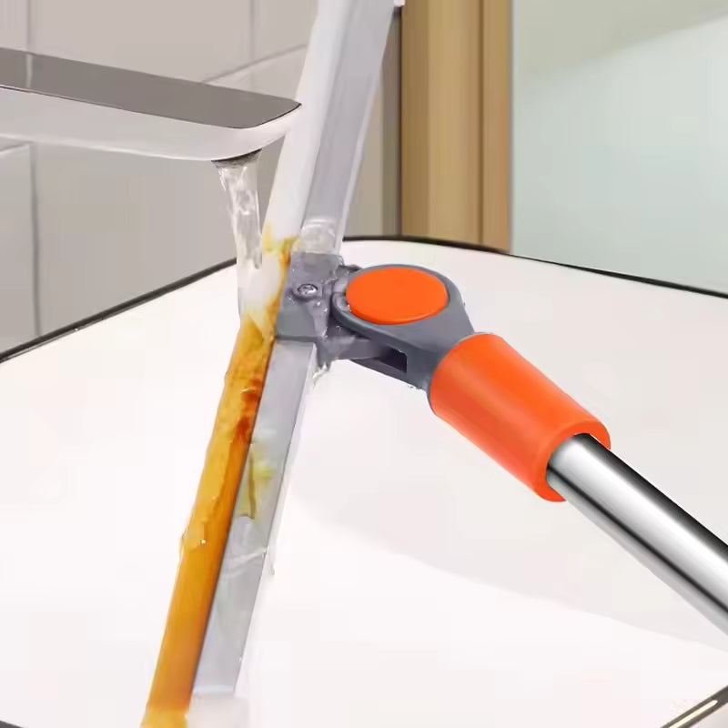 Clarify.pk multi-purpose floor mop with orange handle and stainless steel frame under running tap water