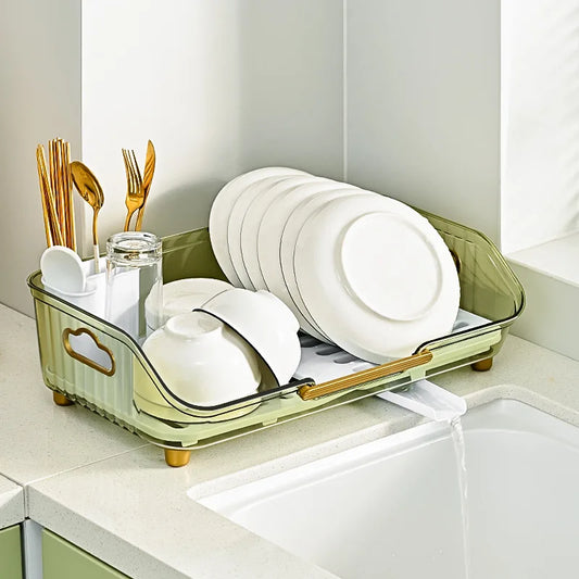 Clarify.pk multifunctional dish drainer with utensil holder in olive green holding plates bowls and cutlery next to kitchen sink