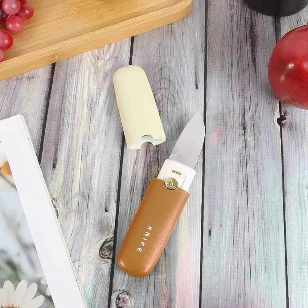 Clarify multifunctional fruit knife peeler with a sleek design and protective cover on a wooden table