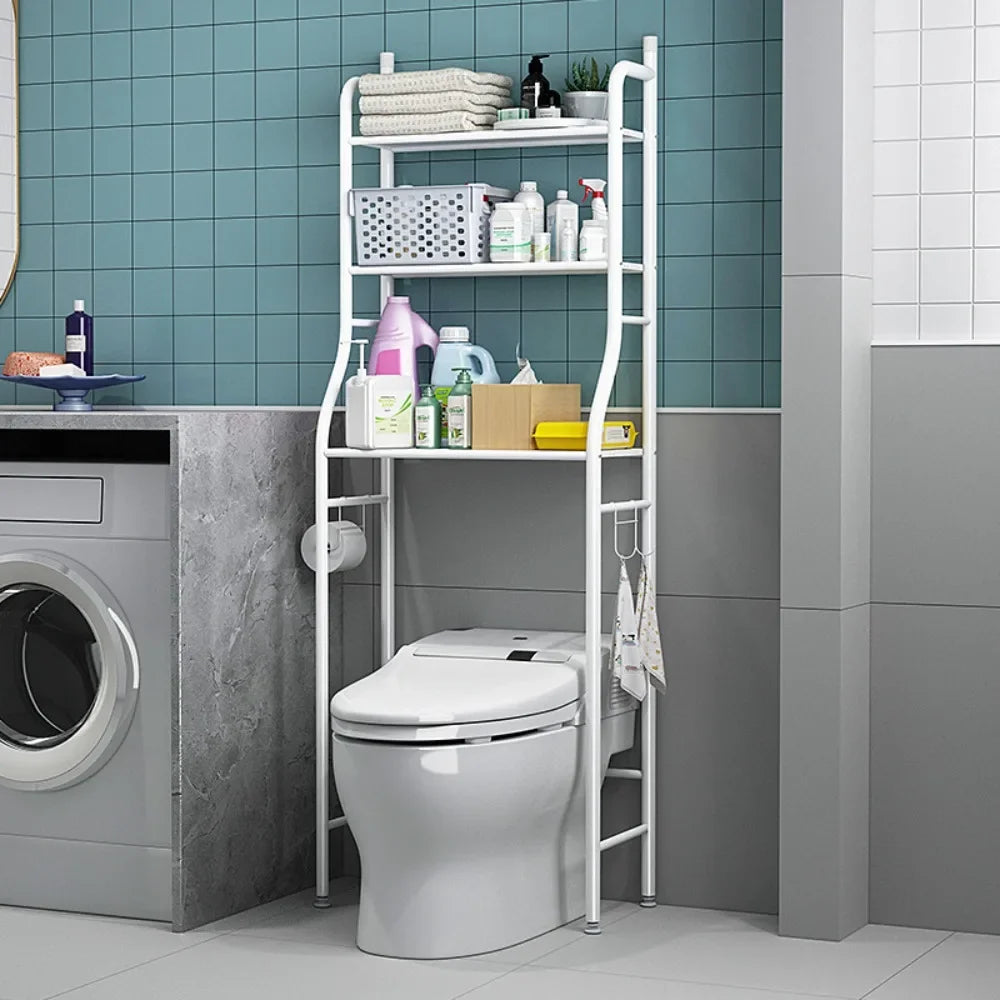 White multifunctional toilet rack with shelves holding towels and toiletries above a toilet in a modern bathroom