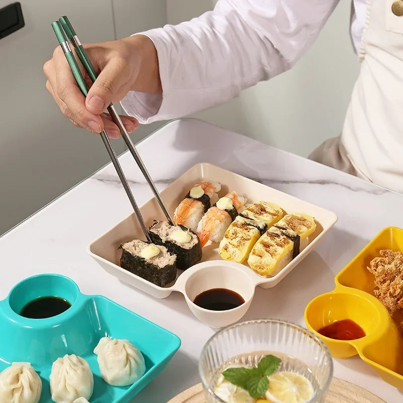 Clarify.pk dumpling plate with sushi and dipping sauce showing multipurpose snack plates with sauce compartment