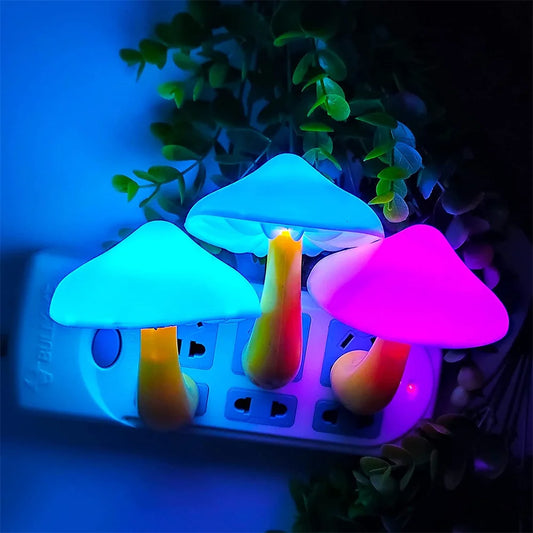 Colorful mushroom LED night light set plugged into a power strip surrounded by greenery