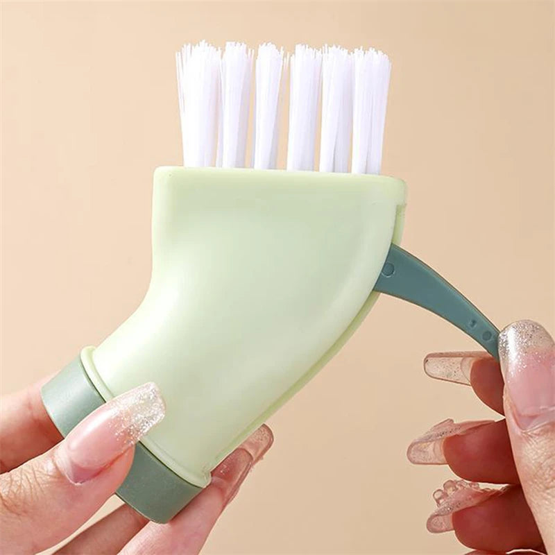 Narrow space cleaning tool for bottles with white bristles and green handle held in hands