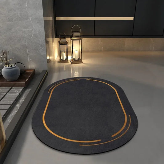 Gray oval-shaped non slip bathroom mat with orange accents on a sleek modern bathroom floor