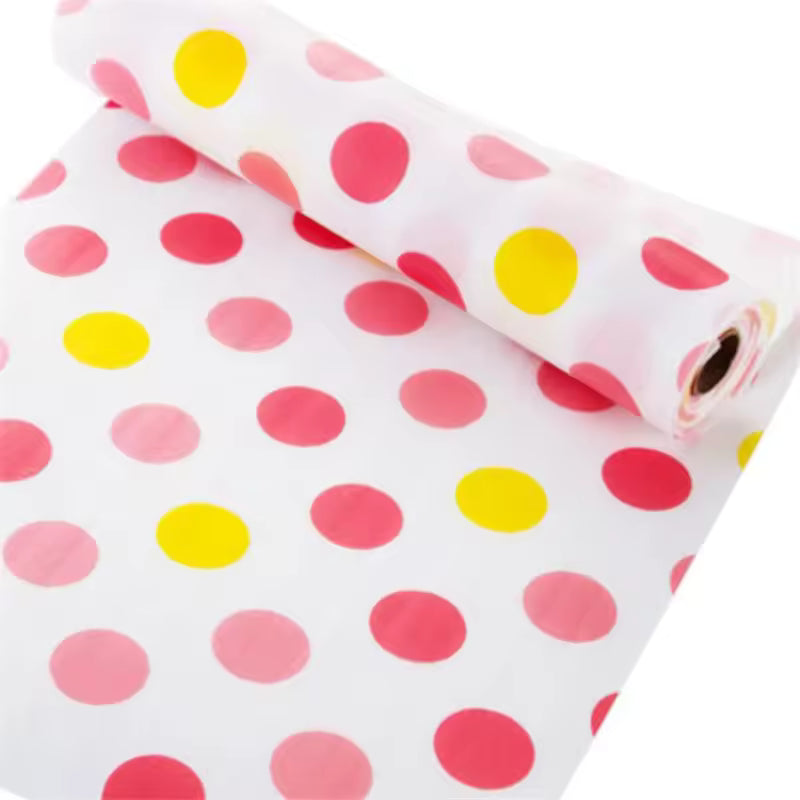Roll of colorful polka dot non-slip cabinet mat for drawers with pink and yellow dots on white background