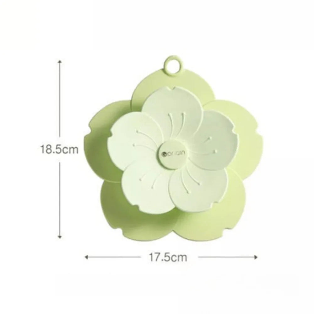 Green flower-shaped silicone drain cover for bathroom measuring 18.5 by 17.5 centimeters