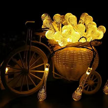 Clarify.pk solar string lights outdoor decorative garland lights glowing warmly in a basket on a bicycle