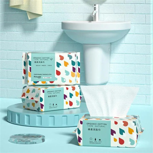 Pack of 70 Cotton Thickened Disposable Face Towel Soft Fabric in colorful packaging near bathroom sink