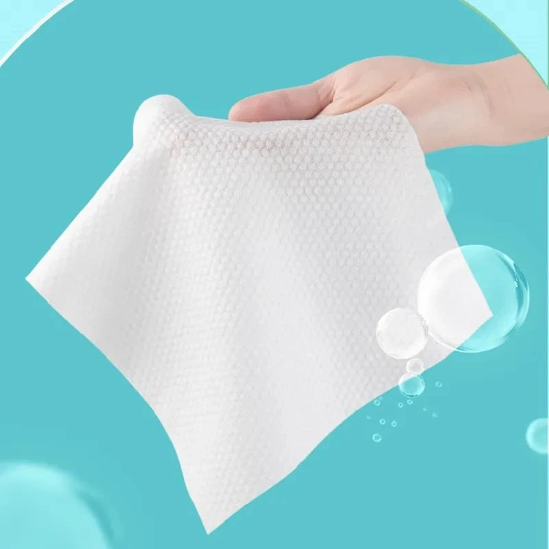 Pack of 70 Cotton Thickened Disposable Face Towel Soft Fabric held by hand against blue background