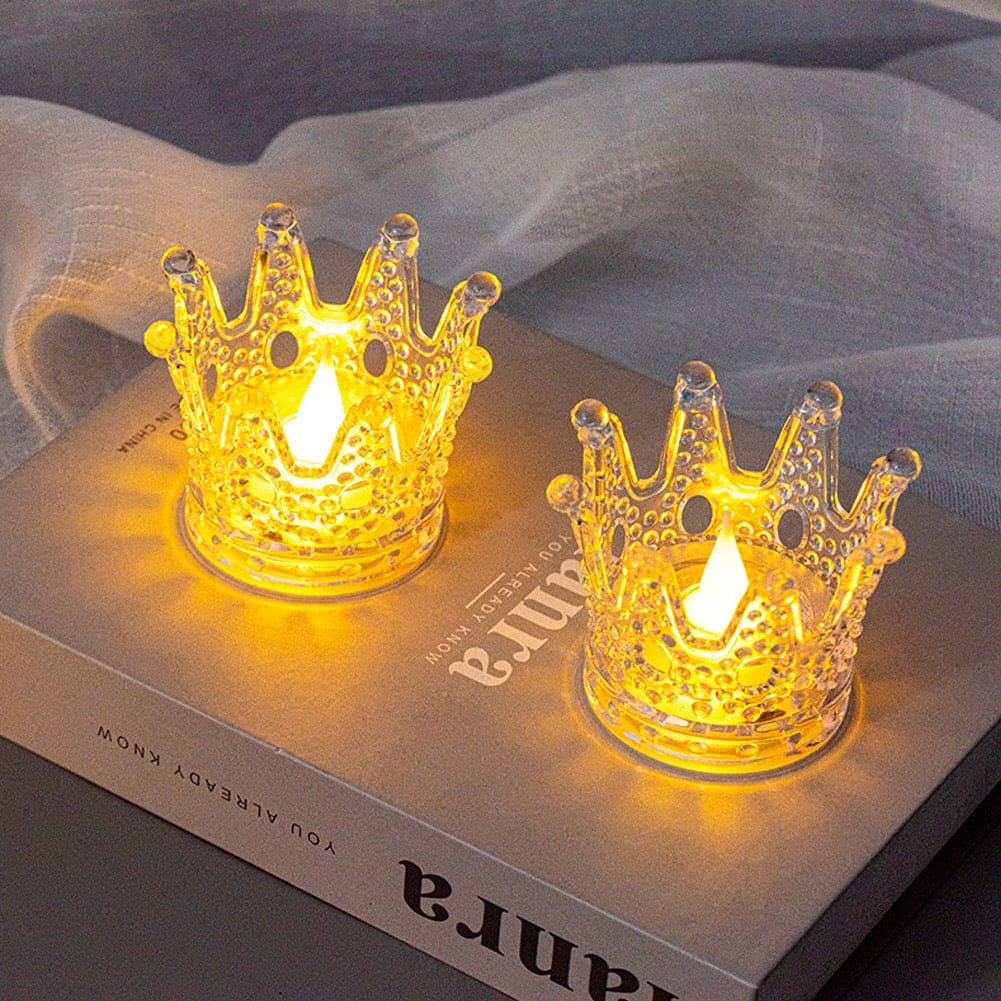 Two glowing crown night light decor pieces with intricate design placed on a book cover