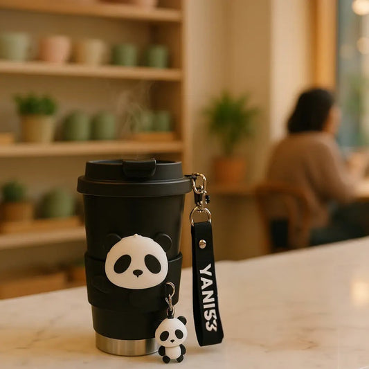 Black panda charm coffee tumbler with cute panda keychain and Yanis3 strap on marble table