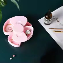Pink 360 degree bow rotating jewelry box with multiple compartments for rings and earrings