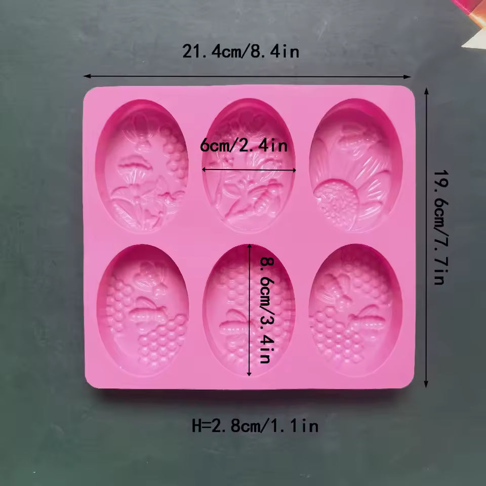 Pink 6 cavity oval soap mold with floral and fruit design cavities by Clarify.pk