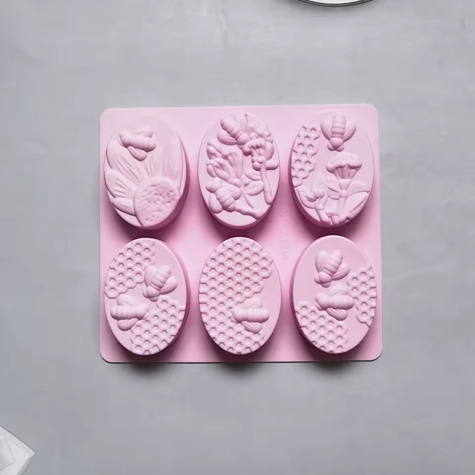 Clarify.pk pink 6 cavity oval soap mold with floral and bee designs for handmade soap crafting