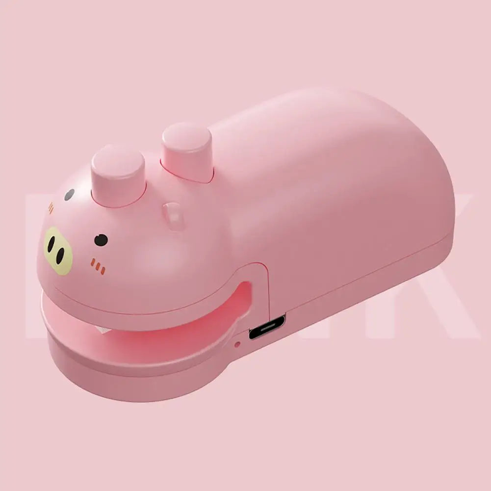 Pink handheld food sealing device shaped like a pig with USB charging port for kitchen use