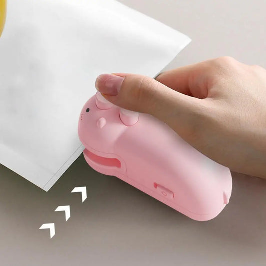 Pink handheld food sealing device sealing a white plastic bag with a person's hand
