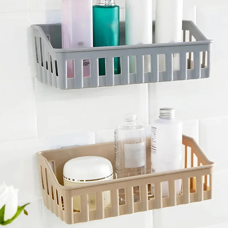 Gray and beige plastic bathroom shelf organizer mounted on tiled wall holding toiletries