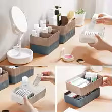 Plastic desktop organizer box holding skincare and makeup products on a vanity table