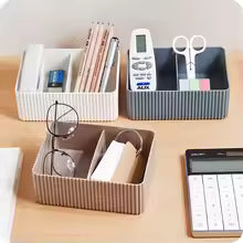 Plastic desktop organizer box in white, gray, and brown holding office supplies on a wooden desk