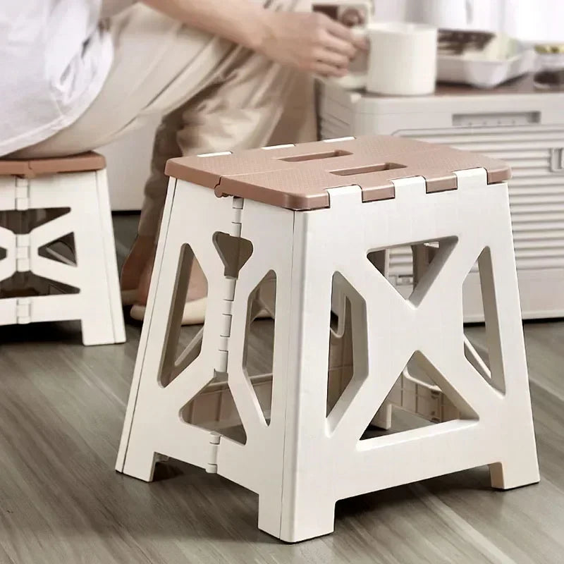 Plastic foldable chair for home use by Clarify.pk in beige and white, ideal for compact seating