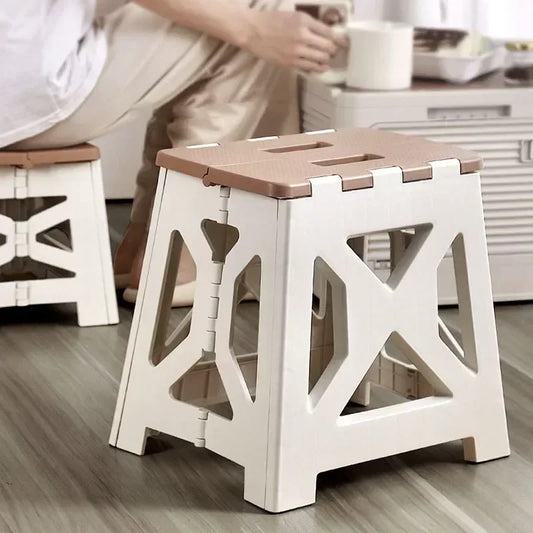 Plastic foldable chair for home use by Clarify.pk in beige and white, ideal for compact seating