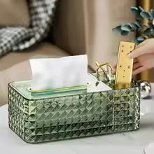 Clear plastic tissue organizer box with geometric design holding tissues and stationery items