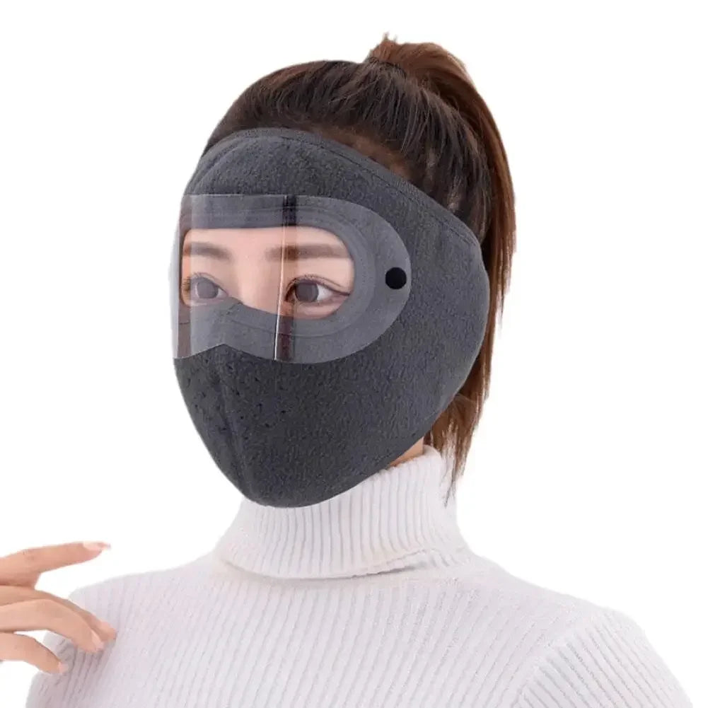 Polar fleece winter mask with goggles in dark gray worn by a person with a white turtleneck sweater