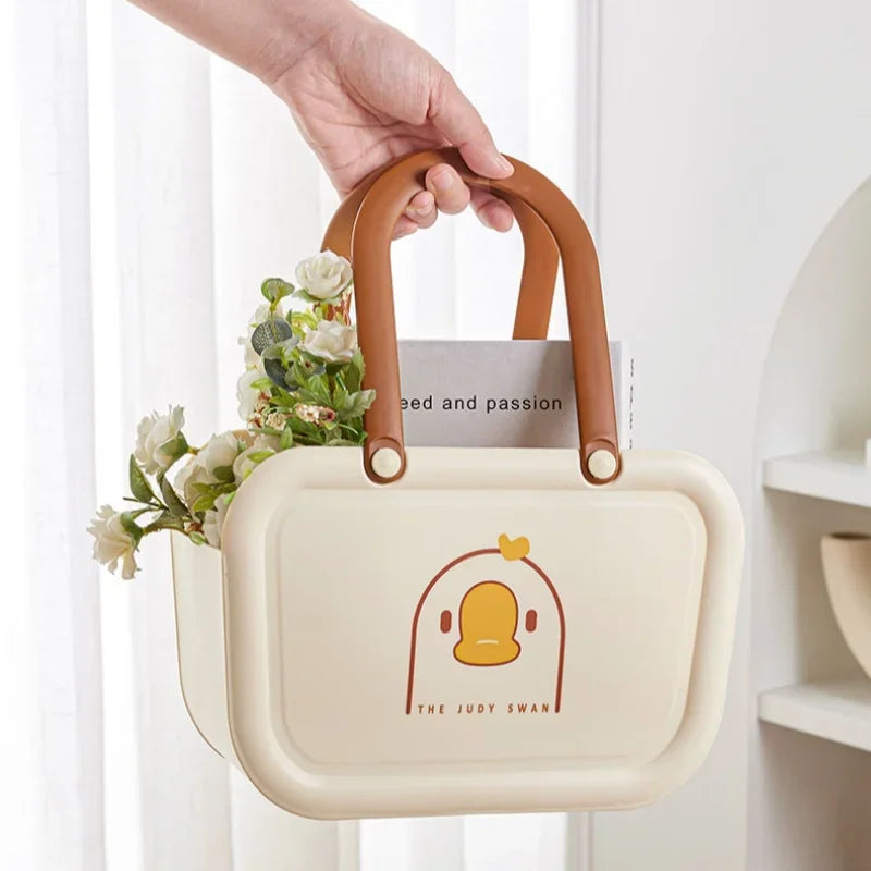 Clarify.pk portable bathroom storage basket with brown handles and duck design holding flowers and book