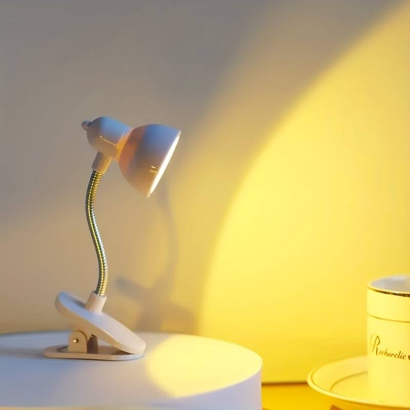 Clarify.pk portable book reading light with flexible neck and clip-on base illuminating a white surface