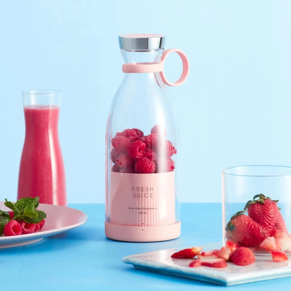 Clarify.pk portable electric juicer blender with fresh raspberries and strawberries on a blue background