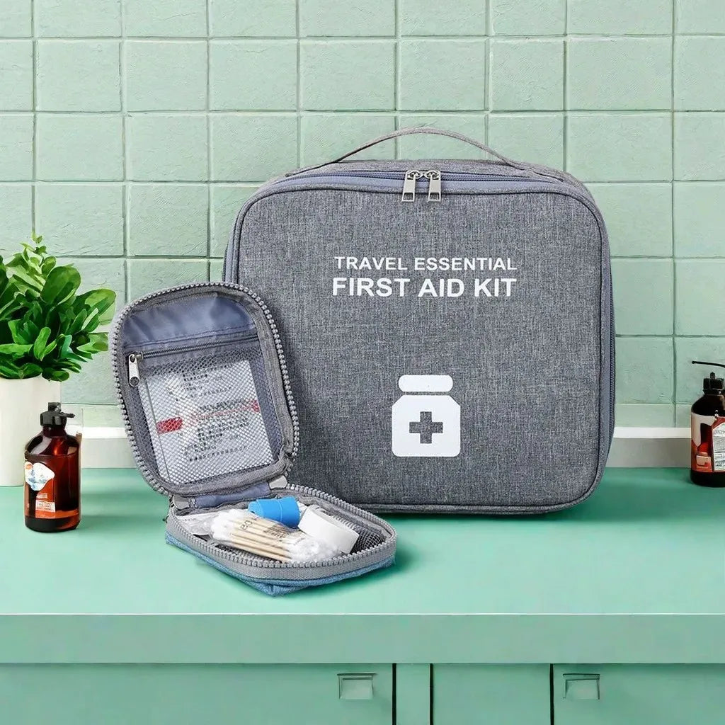 Clarify.pk gray portable first aid kit bag with travel essential supplies on a green countertop