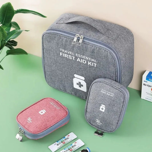 Gray and red portable first aid kit bag set with travel essential design and multiple compartments