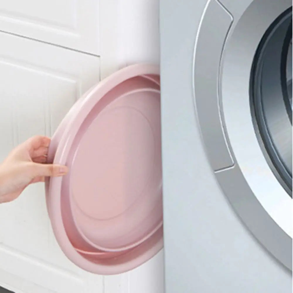 Clarify.pk pink portable folding laundry tub basin being folded near washing machine