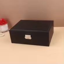 Clarify.pk black portable jewelry box for girls with secure silver clasp on beige surface