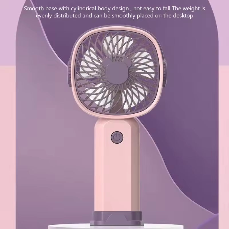 Pink portable mini fan USB rechargeable with smooth base and cylindrical body design for desktop use