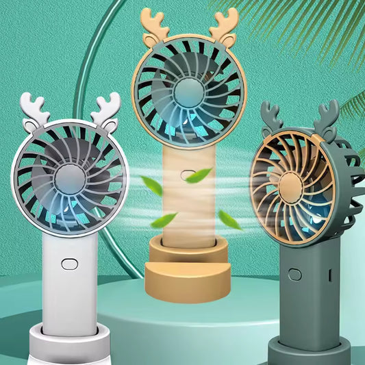 Three colorful mini fan with phone stand designs with reindeer antlers on a green background