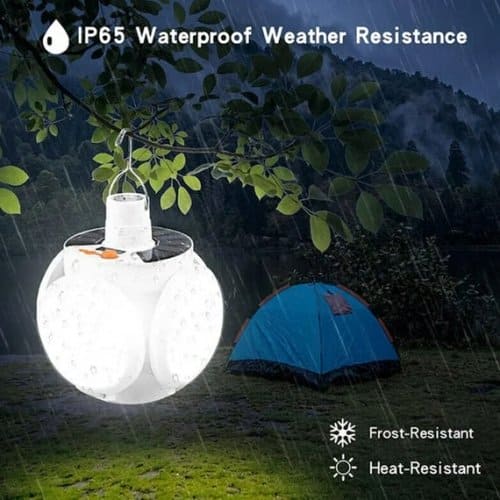 Portable rechargeable led lantern hanging from a tree in rain showing IP65 waterproof and weather resistance