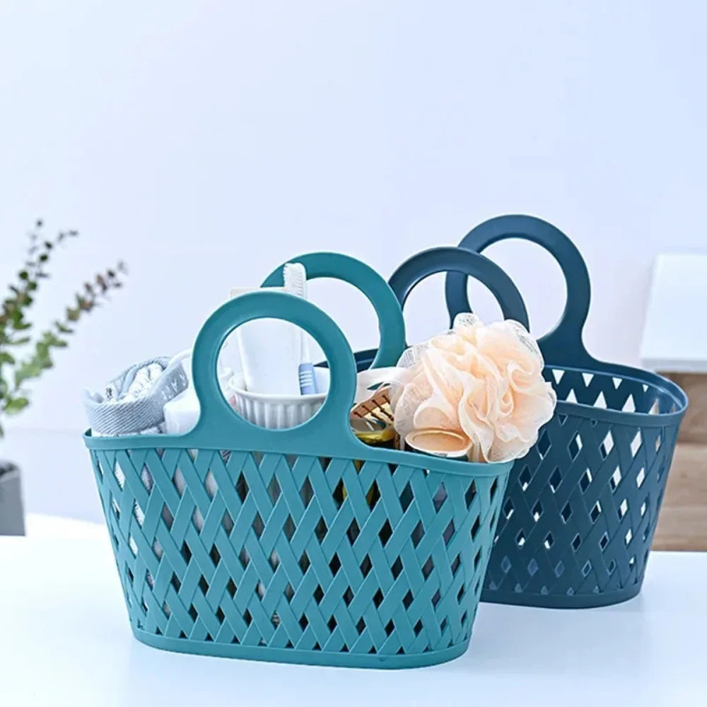 Two Clarify.pk portable storage baskets in teal and navy blue with handles, holding bathroom essentials