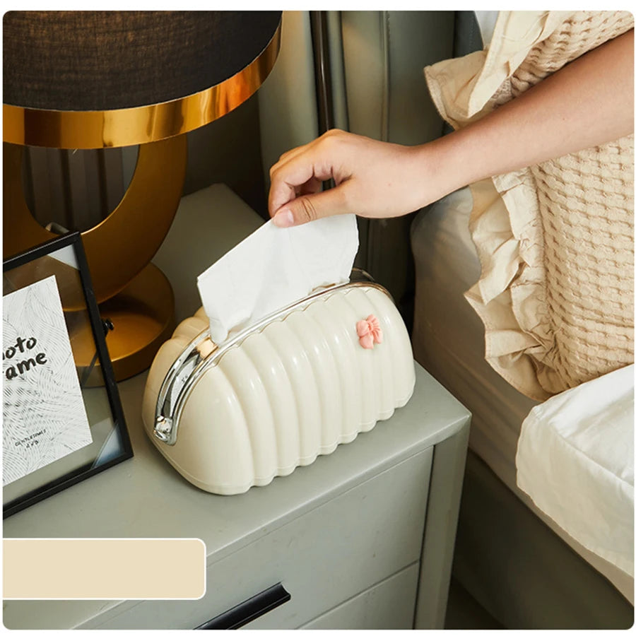 Premium Plastic Tissue Holder on bedside table with hand pulling tissue in cozy bedroom