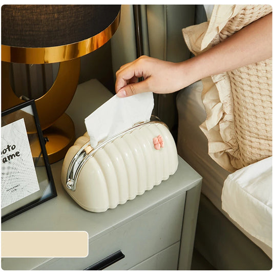 Premium Plastic Tissue Holder on bedside table with hand pulling tissue in cozy bedroom