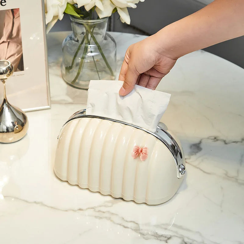 Premium Plastic Tissue Holder by Clarify.pk with cream ribbed design and small pink bow on white marble surface