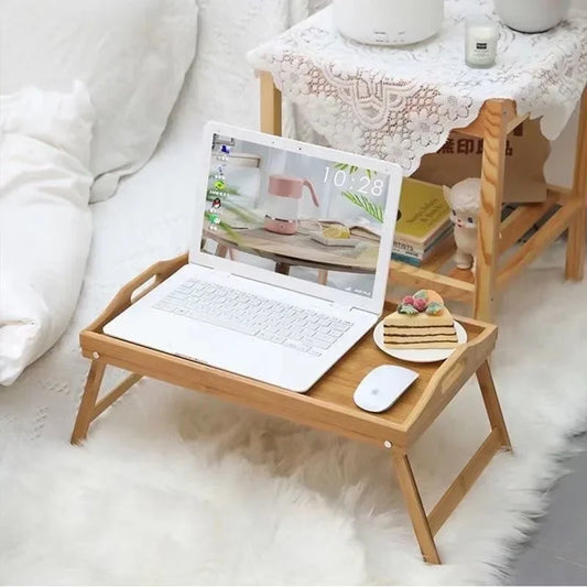 Premium quality natural bamboo table with foldable legs holding a laptop, mouse, and dessert plate