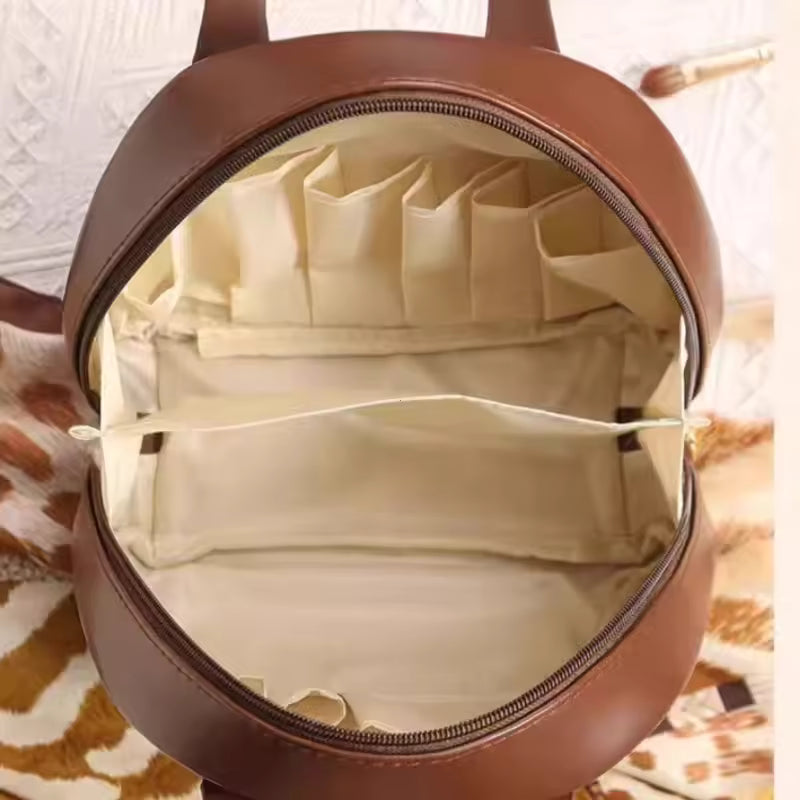 Open brown PU leather cosmetic bag for women showing multiple beige compartments and pockets inside