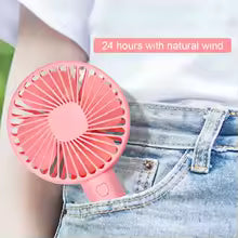 Rechargeable mini portable fan in pink clipped to jeans pocket for on-the-go cooling