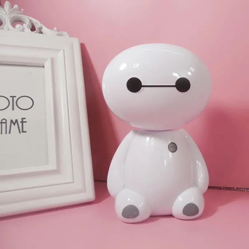 White rechargeable study lamp with eye protection shaped like a cute robot on a pink surface