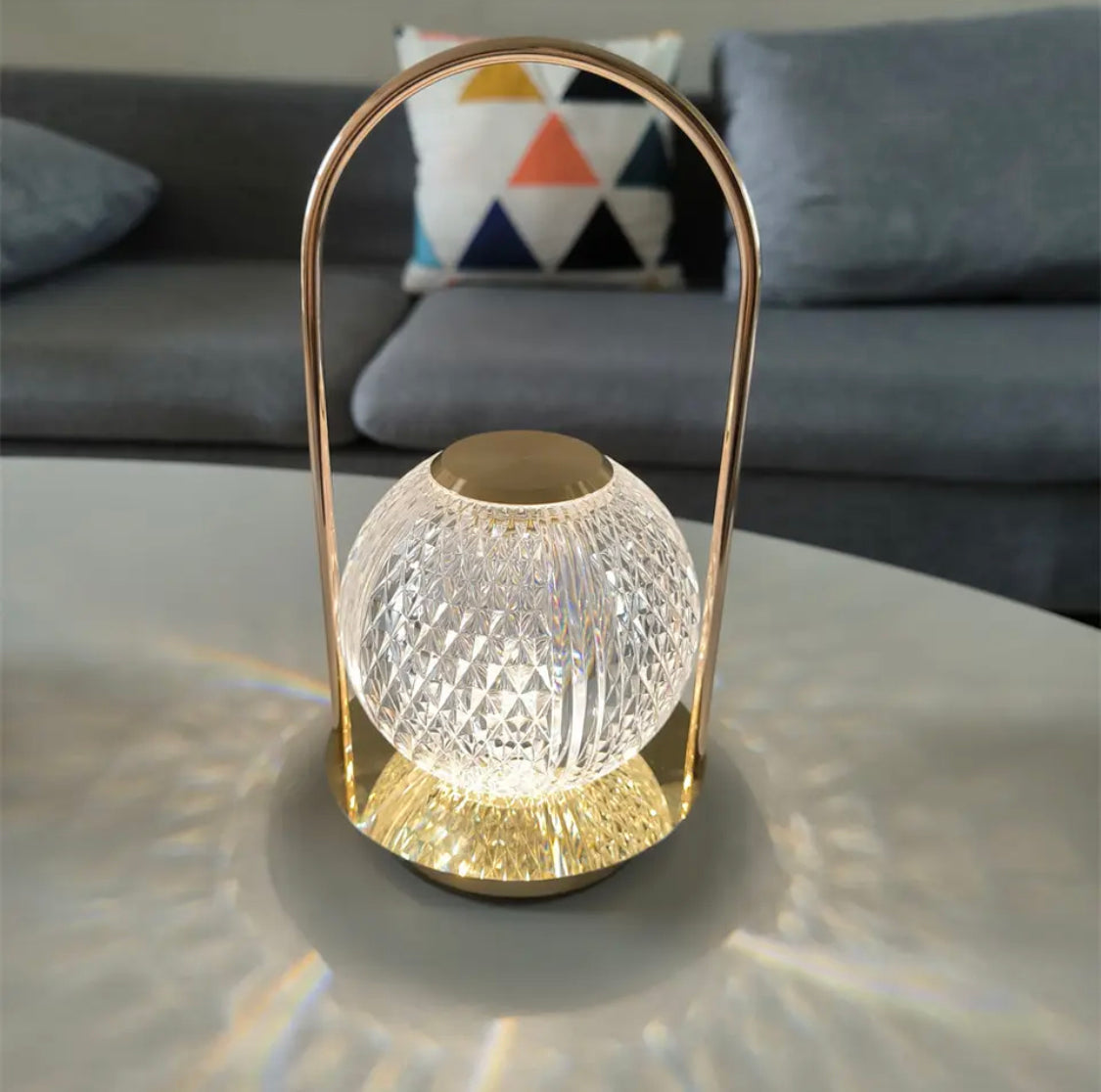 Clarify.pk retro metal table lamp with glass globe and gold frame casting light on white table