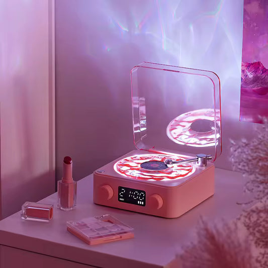 Clarify.pk retro turntable Bluetooth speaker in pink with glowing LED lights and clear dust cover on vanity table