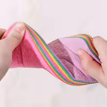 Hands holding colorful reusable dishcloths for kitchen with soft textured fabric