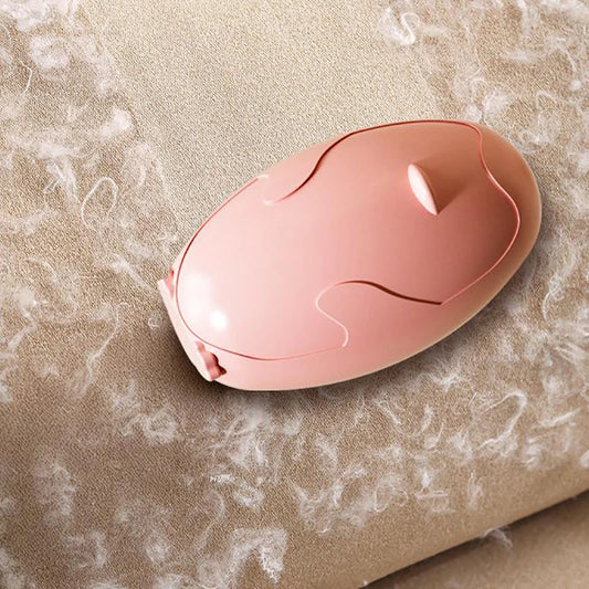 Clarify.pk pink reusable lint remover on beige fabric with visible lint particles